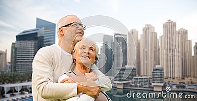 Senior couple hugging over dubai city waterfront Stock Photo