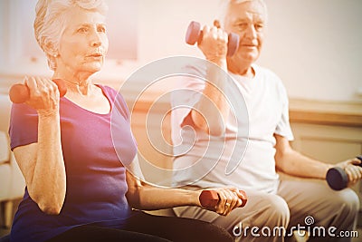 Senior couple lifting dumbbells Stock Photo