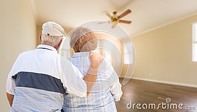 Senior Couple Looking Into Empty Room of House Stock Photo