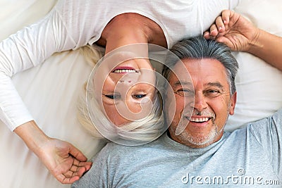 Senior couple lying in bed Stock Photo