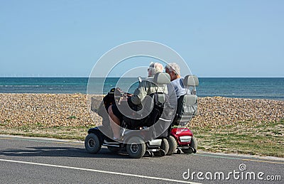 Senior couple. Independence with disability. Mobility scooters. Editorial Stock Photo