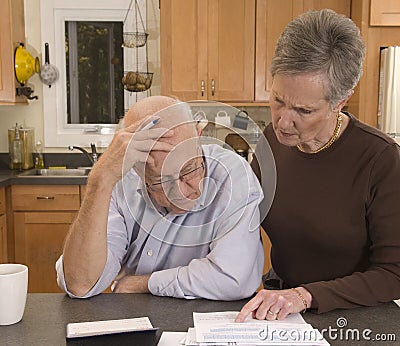 Senior couple paying bills Stock Photo