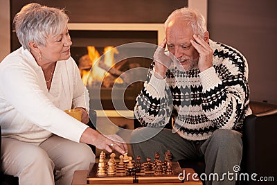 Senior couple playing chess at home Stock Photo