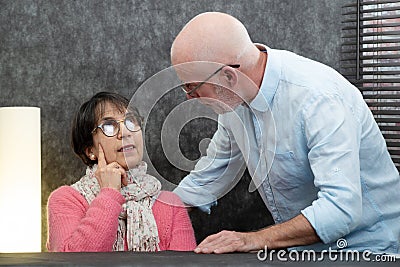 Senior couple with problems at home, woman angry Stock Photo