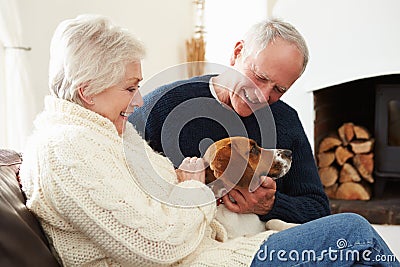 Senior Couple Relaxing At Home With Pet Dog Stock Photo