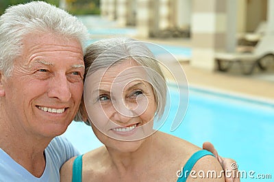 Senior couple relaxing at pool Stock Photo