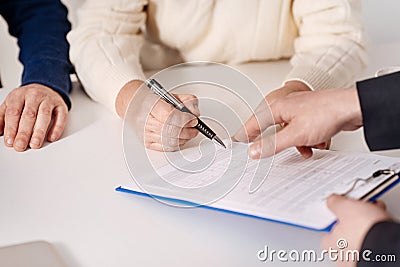 Senior couple signing important document at home Stock Photo