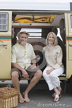 Senior Couple Sit In Campervan With Their Pet Dog Stock Photo