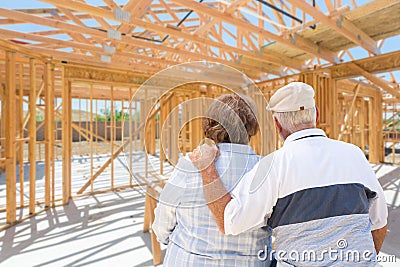 Sweet Senior Couple On Site Inside Their New Home Construction Framing Stock Photo