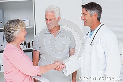 Senior couple smiling while visiting doctor Stock Photo