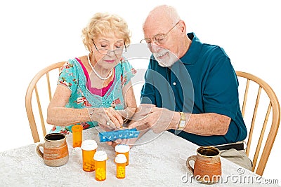 Senior Couple Sorts Medications Stock Photo