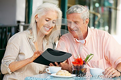 Senior Couple Using Tablet Computer Cafe Stock Photo