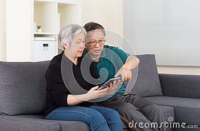 Senior couple using tablet computer Stock Photo