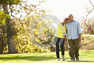 Senior Couple Walking Through Autumn Woodland Stock Photo