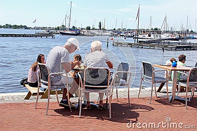 Senior couple young people terrace lake, Loosdrecht, Netherlands Editorial Stock Photo