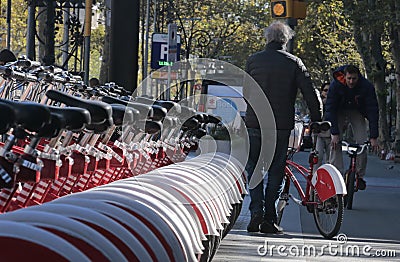 Senior cyclist picking a bicycle in Barcelona Editorial Stock Photo