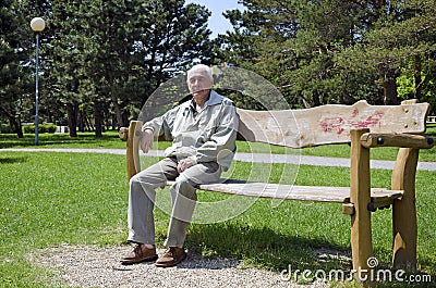 Senior dozing on bench Stock Photo