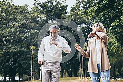 Senior elderly couple man with big laughing and surprised or excited woman in the park. Happy retired life of older people. Marria Stock Photo