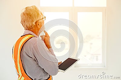 Senior engineer thinking project looking at windows Stock Photo