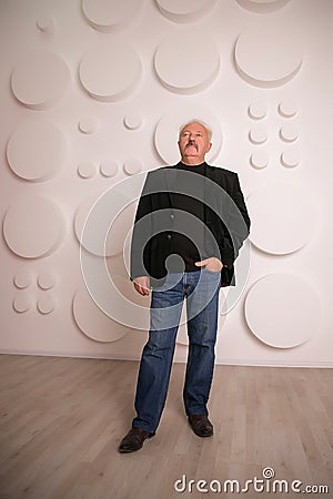 Senior expertise gray hair businessman posing interior white Stock Photo