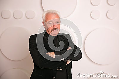Senior expertise gray hair businessman posing interior white Stock Photo
