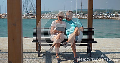 Senior family couple with pad on waterfront Stock Photo