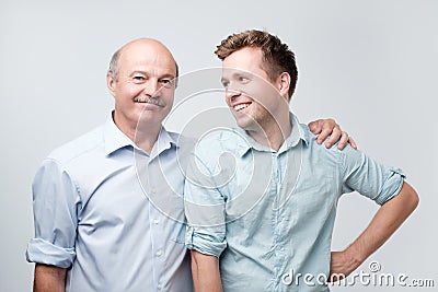 father is proud of his mature son. He is holding his shoulder being happy to have such a great child Stock Photo
