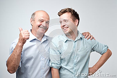 Senior father is proud of his mature son. Stock Photo