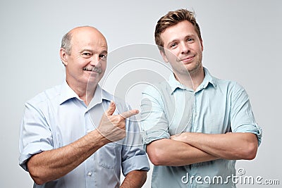 Senior father is proud of his mature son. Stock Photo