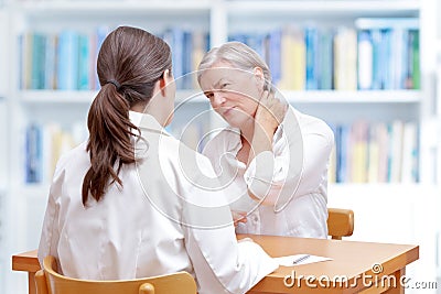 Doctor patient neck pain fibromyalgia Stock Photo