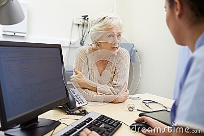 Senior Female Patient Has Appointment With Nurse Stock Photo