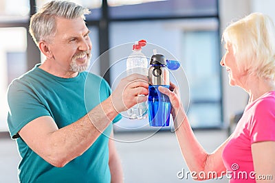 Senior fitness couple holding bottles with water gym Stock Photo