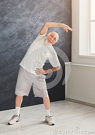 Senior man warmup stretching training indoors Stock Photo