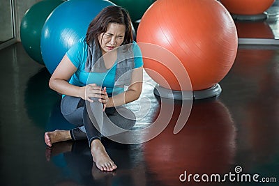 Senior fitness woman injury knee pain while exercising in gym. aged lady suffering from Arthritis . Old female workout .Mature Stock Photo