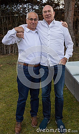 Senior friends hugged in a garden Stock Photo