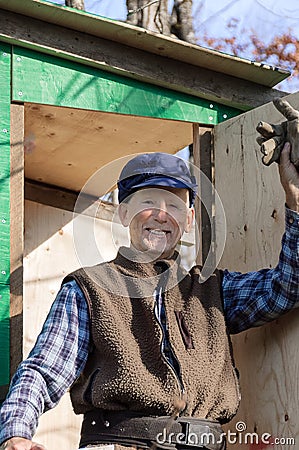 Senior in front of his hunter cabin Stock Photo