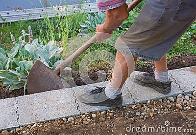 Senior gardener build a wall fundament Stock Photo
