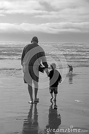 Senior Grandfather and Child Silhouette on Beach in BW Stock Photo