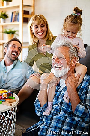 Senior grandparents playing with grandchildren and having fun with family Stock Photo