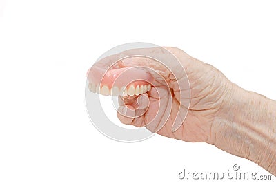 Senior hand with Dental prosthesis Stock Photo