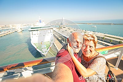 Senior happy couple taking selfie on ship at Barcelona harbour Stock Photo