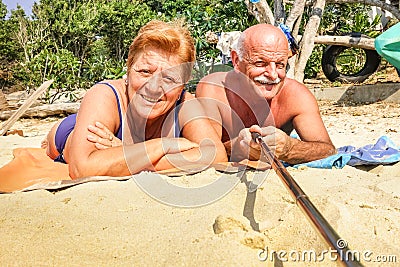 Senior happy couple taking selfie with stick in Thailand trip Stock Photo