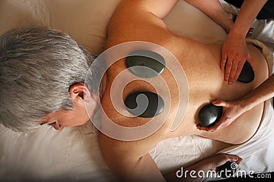 Senior Health Massage Hot Mineral Stone Stock Photo