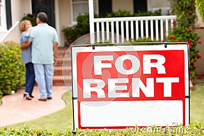 Senior Hispanic couple renting new home Stock Photo