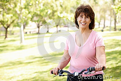 Senior Hispanic woman with bike Stock Photo