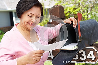 Senior Hispanic Woman Checking Mailbox Stock Photo