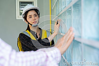 Senior home inspector checking home defects and teaching young engineers, before handing it over to client. Young engineers learn Stock Photo