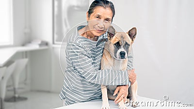 An senior hugging dog in smiling face, white background copy space Stock Photo