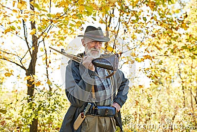 Senior hunter carry rifle gun on shoulder Stock Photo