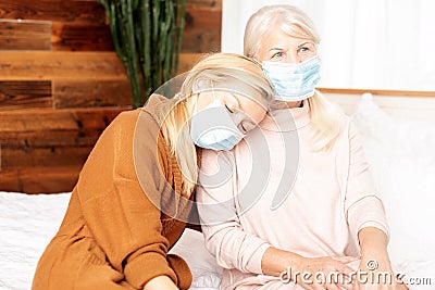 Senior ill woman with caring daughter at home Stock Photo